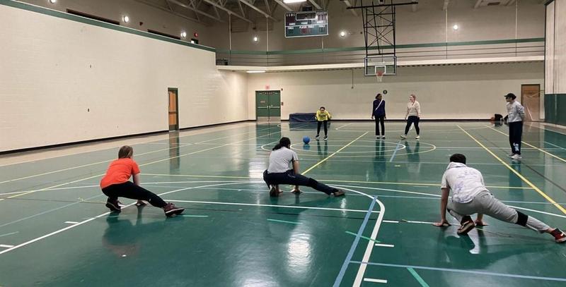goalball players are practicing on a gymnasium floor